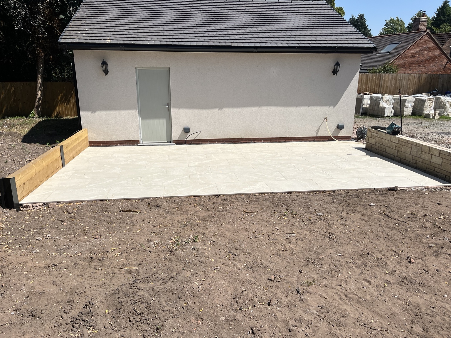 Second porcelain patio area beside an outbuilding