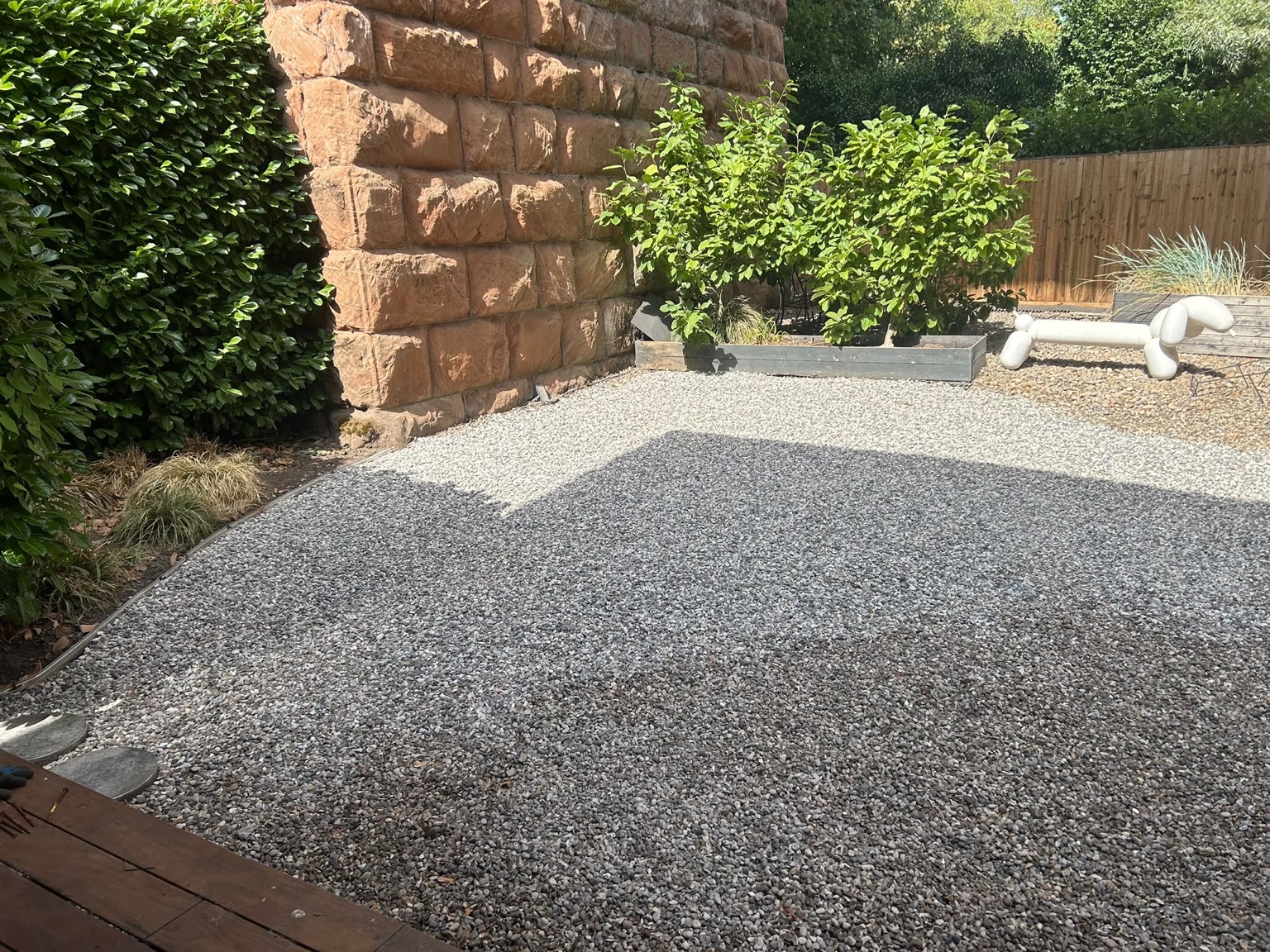 Garden area transformed from gravel to a finished stone surface